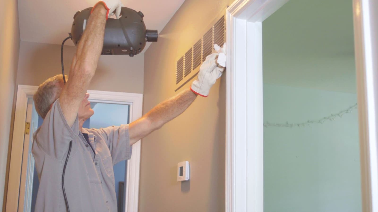 Person cleaning vents